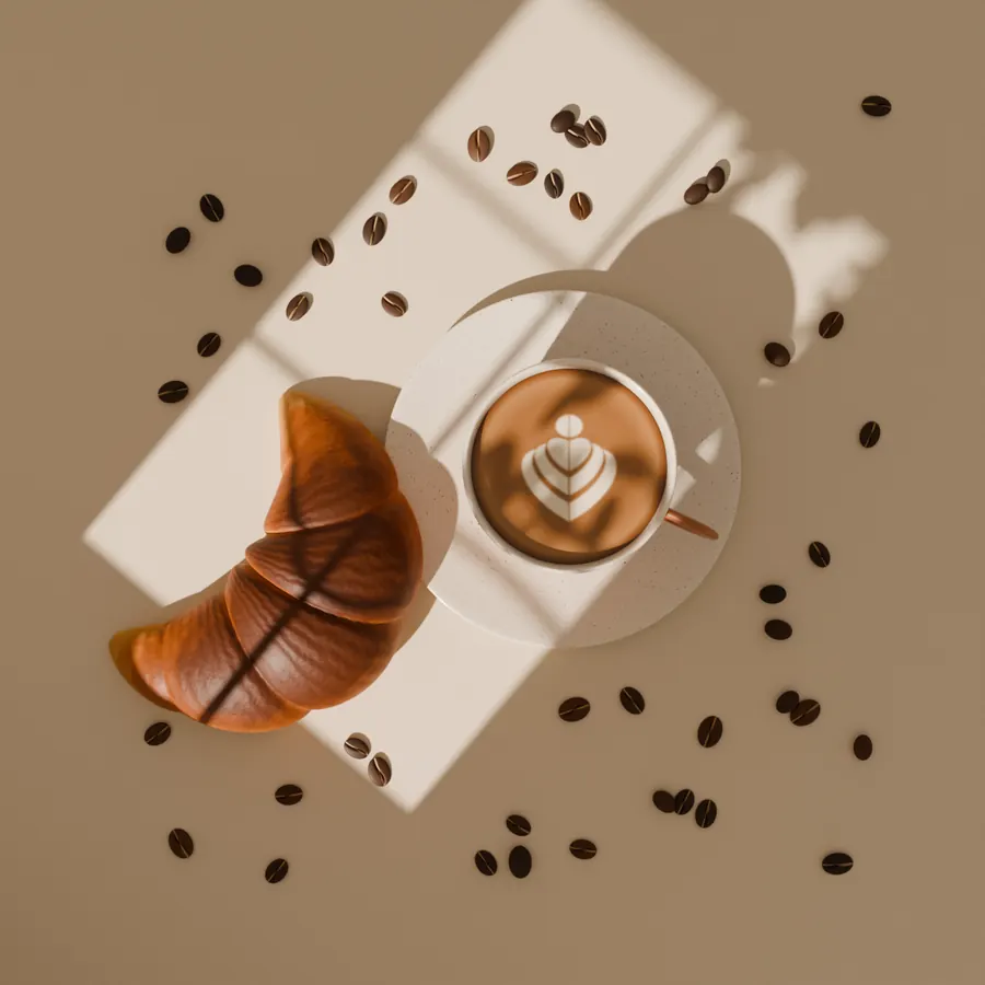 Pastries, coffee and loaves laid out on a linen cloth, seen from above.